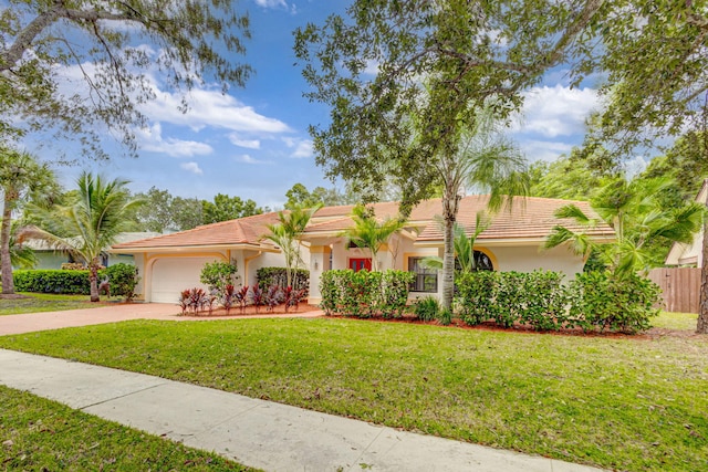 view of front of house featuring a front lawn and a garage