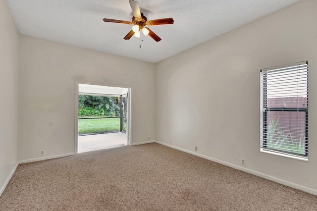 empty room featuring carpet floors, a textured ceiling, and ceiling fan