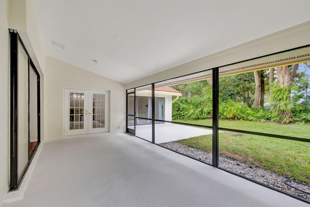 unfurnished sunroom with vaulted ceiling and french doors