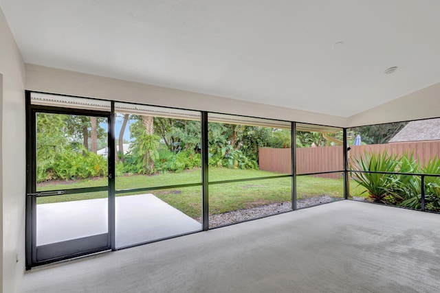 unfurnished sunroom with lofted ceiling