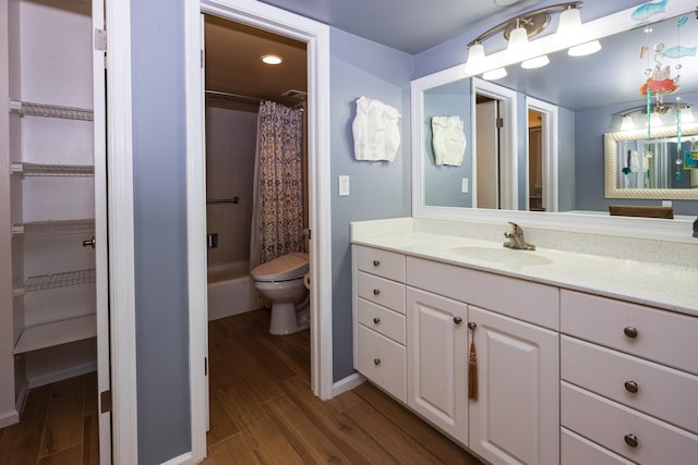 bathroom featuring wood-type flooring, vanity, and toilet