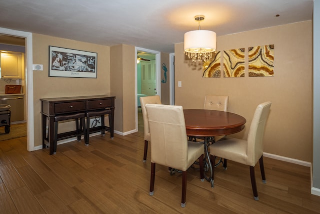 dining room featuring wood-type flooring and a chandelier