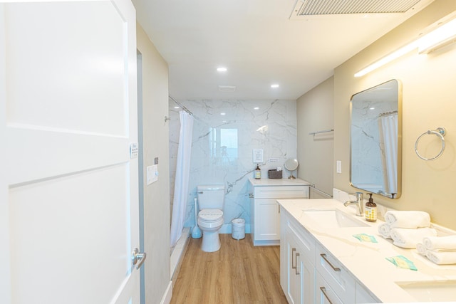 bathroom featuring curtained shower, toilet, vanity, and hardwood / wood-style flooring