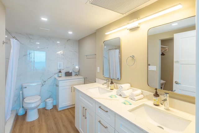 bathroom with a shower with shower curtain, vanity, hardwood / wood-style flooring, and toilet