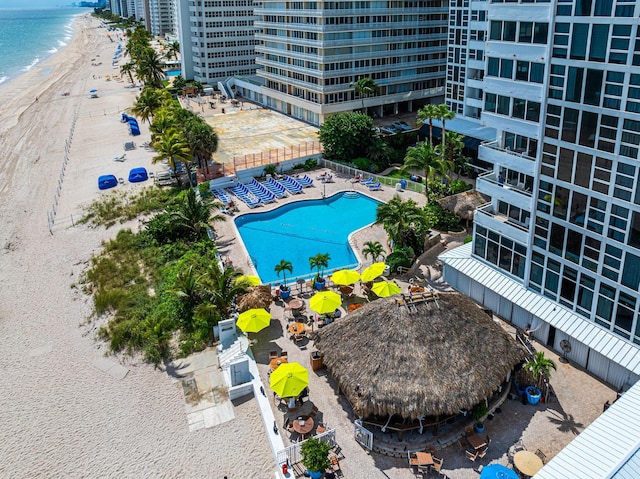 bird's eye view featuring a water view and a beach view