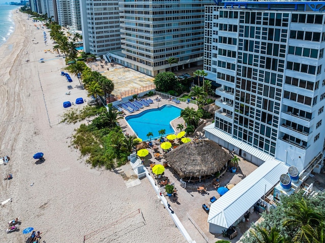 drone / aerial view featuring a water view and a beach view