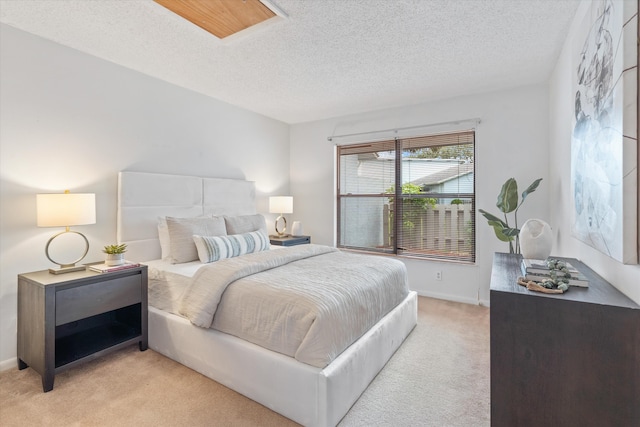 carpeted bedroom featuring a textured ceiling