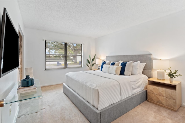 carpeted bedroom featuring a textured ceiling