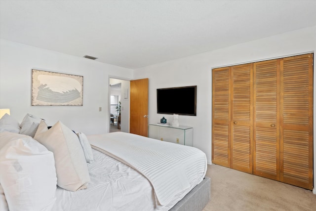 bedroom featuring a closet and light colored carpet