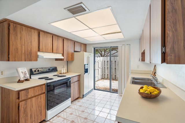 kitchen with white appliances and sink