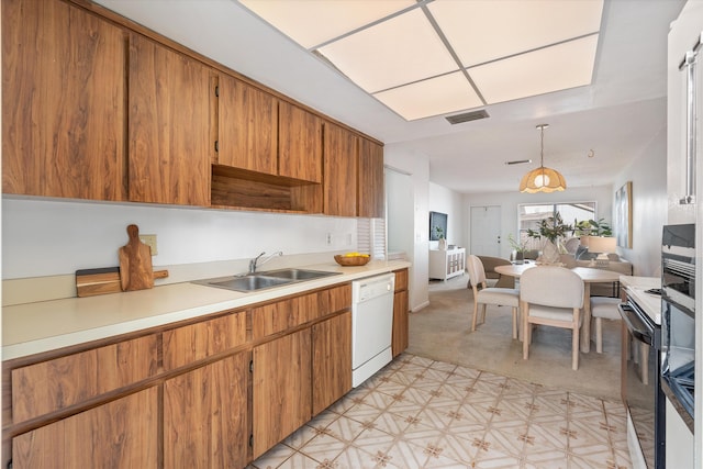 kitchen with dishwasher, decorative light fixtures, and sink