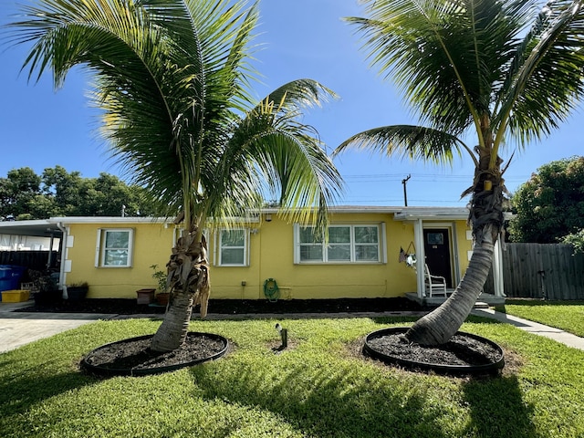 view of front of house with a carport and a front yard