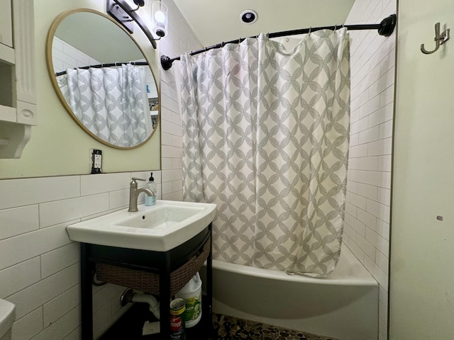 bathroom featuring vanity, tile walls, and shower / bath combo