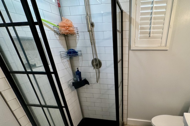 bathroom featuring toilet and a shower