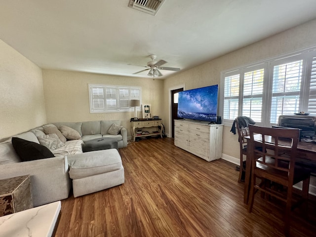 living room with wood-type flooring and ceiling fan