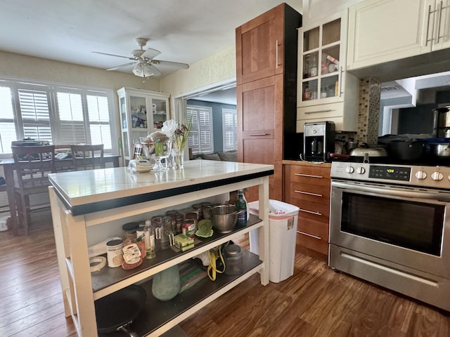 kitchen featuring a center island, dark hardwood / wood-style floors, ceiling fan, and electric stove