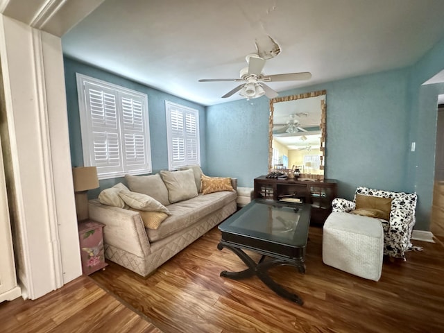 living room featuring hardwood / wood-style flooring and ceiling fan