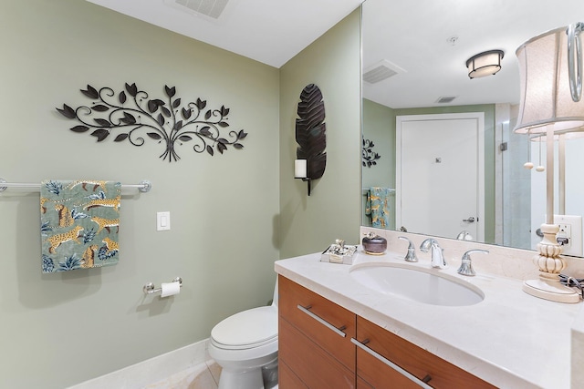 bathroom with visible vents, toilet, tile patterned flooring, baseboards, and vanity