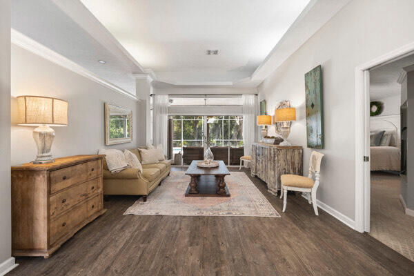 living room with ornamental molding and dark hardwood / wood-style flooring