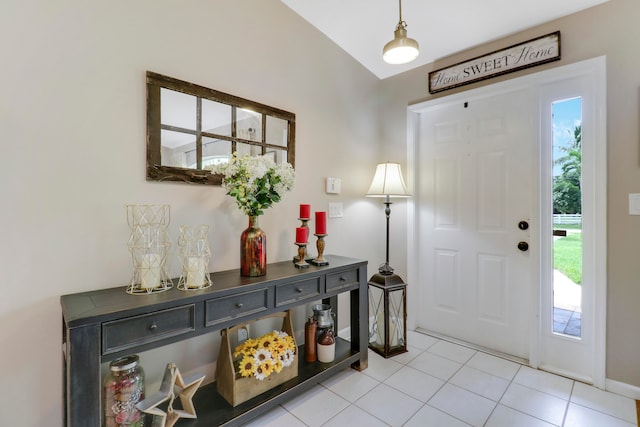 tiled entrance foyer featuring vaulted ceiling