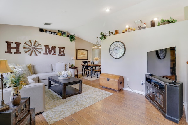 living room featuring wood-type flooring and lofted ceiling