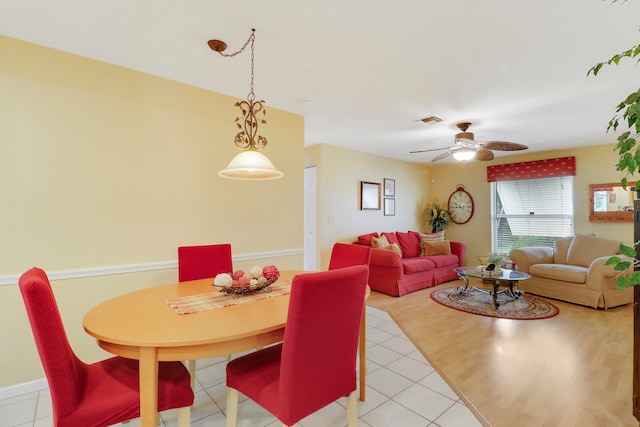 dining space with ceiling fan and light tile patterned floors