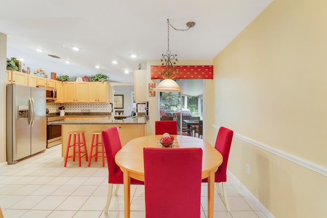 tiled dining area featuring vaulted ceiling