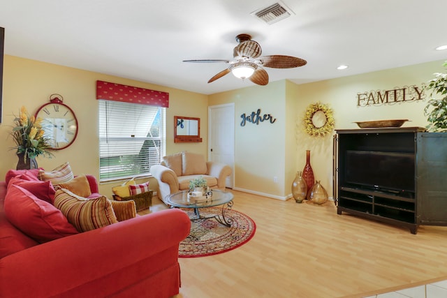 living room featuring ceiling fan and hardwood / wood-style flooring