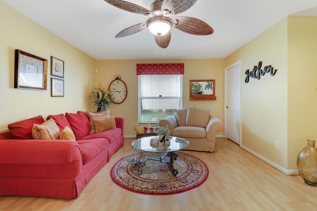 living room featuring wood-type flooring and ceiling fan