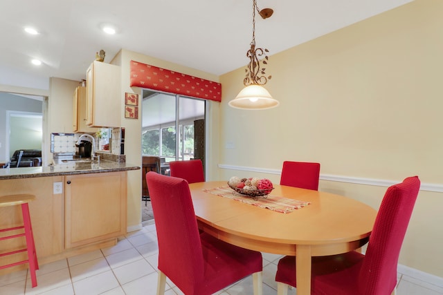 tiled dining room with sink