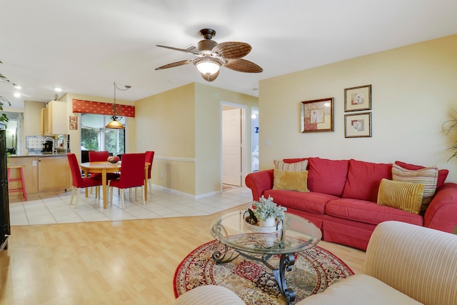 living room with ceiling fan and light wood-type flooring