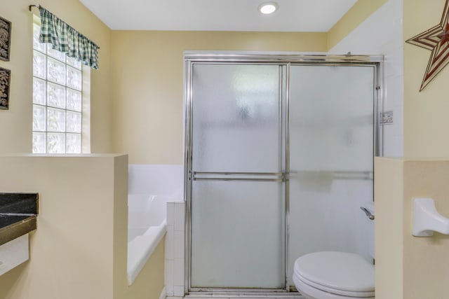 bathroom featuring walk in shower and toilet