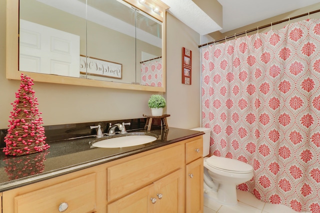 bathroom with tile patterned flooring, vanity, and toilet