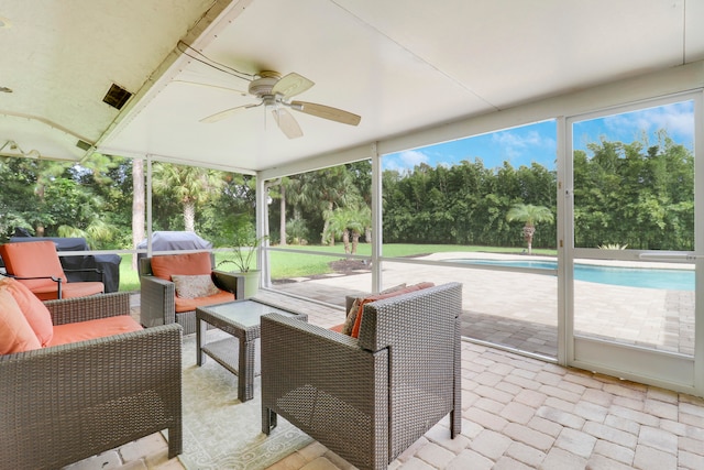 sunroom / solarium featuring ceiling fan