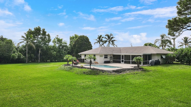 rear view of property with a sunroom, a yard, and a patio