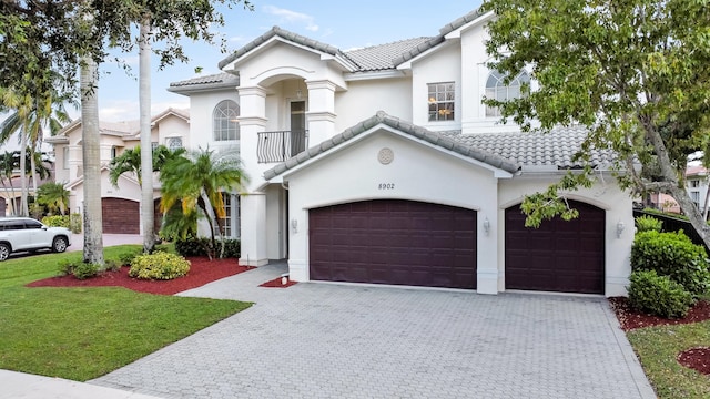 mediterranean / spanish-style house with a balcony and a front yard