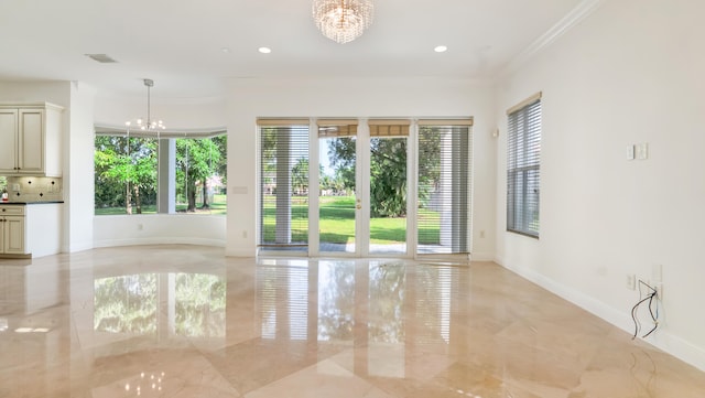 unfurnished room with crown molding and a chandelier