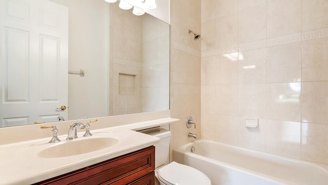 full bathroom featuring vanity, toilet, and tiled shower / bath combo