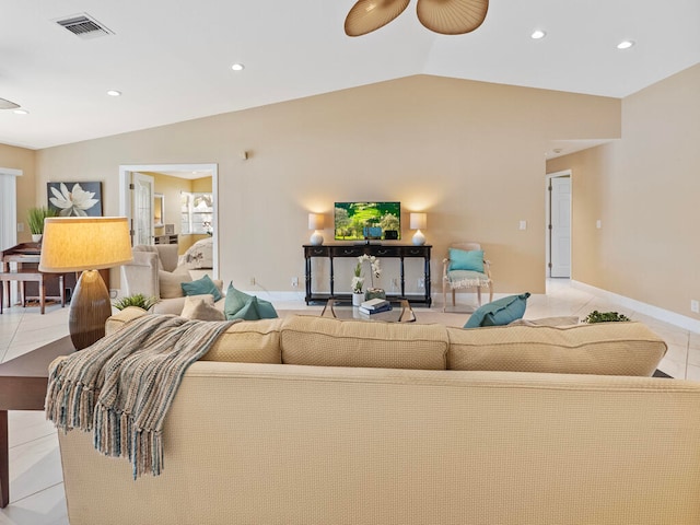 living room featuring vaulted ceiling and light tile patterned floors