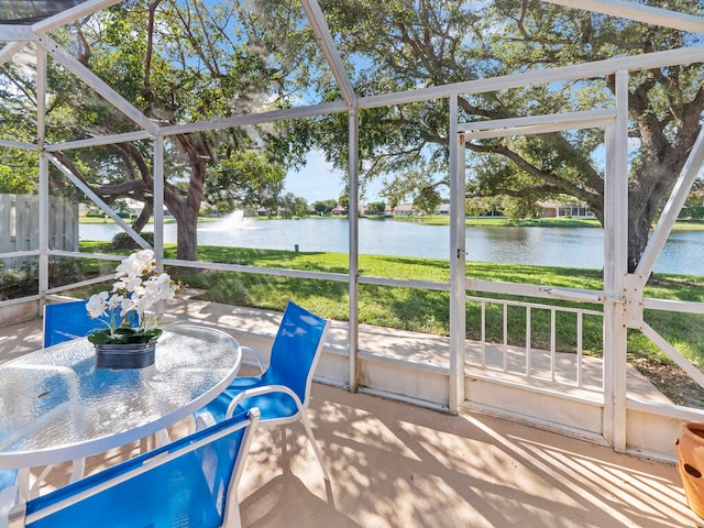 sunroom / solarium with a water view