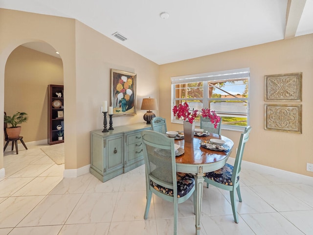 dining room with lofted ceiling