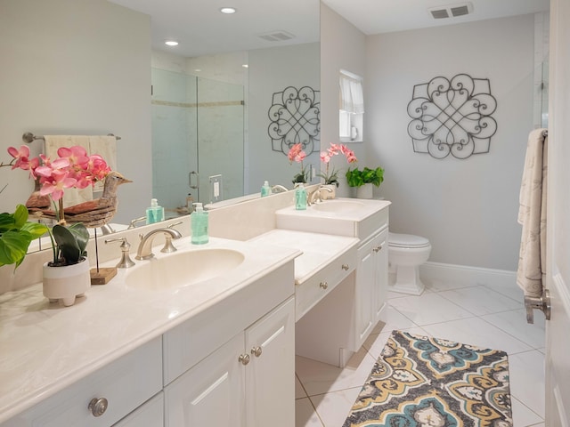 bathroom featuring vanity, toilet, tile patterned floors, and an enclosed shower