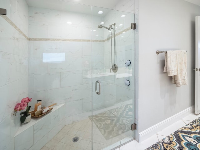 bathroom featuring a shower with door and tile patterned flooring