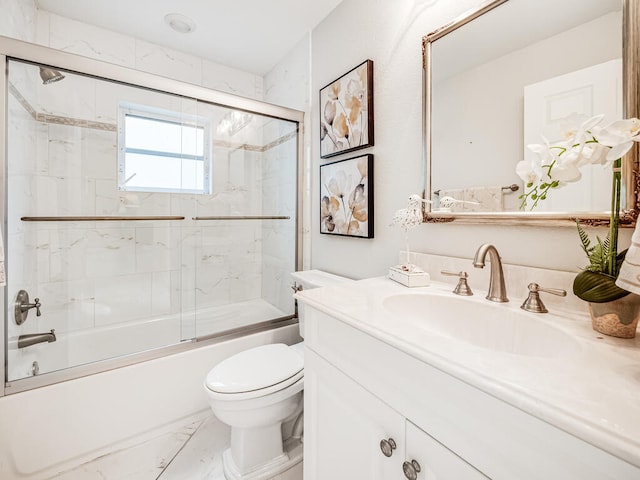 full bathroom with vanity, shower / bath combination with glass door, and toilet