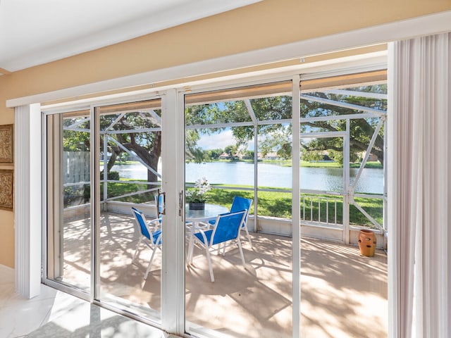 doorway to outside with a water view