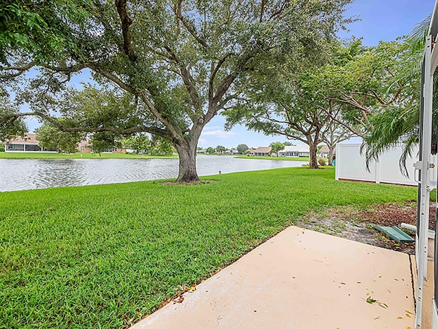 view of yard featuring a patio and a water view