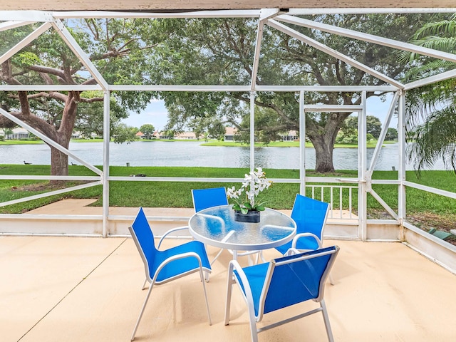 sunroom / solarium featuring a water view