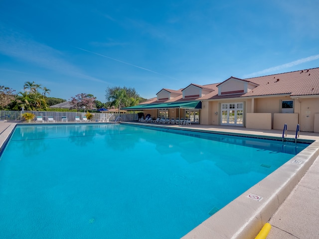 view of pool featuring french doors