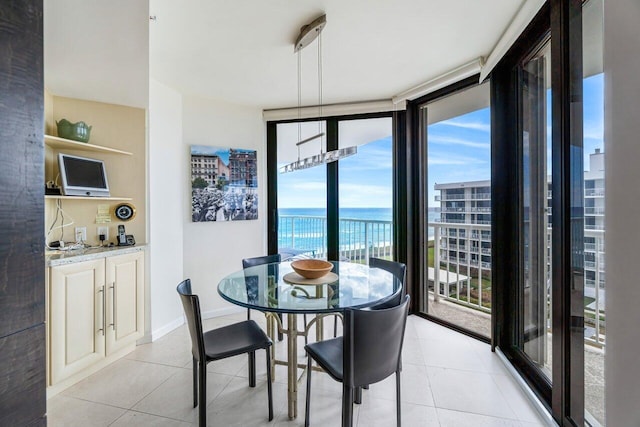 tiled dining space featuring a water view