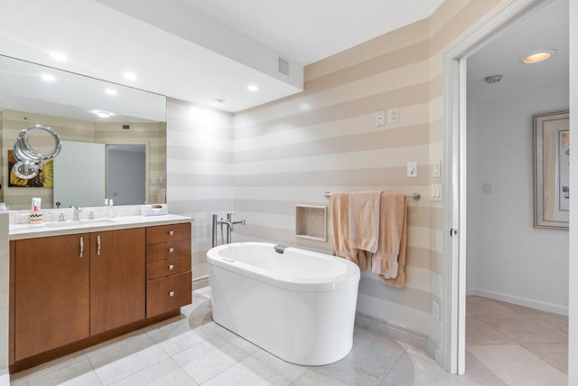 bathroom with vanity, a washtub, and tile patterned flooring